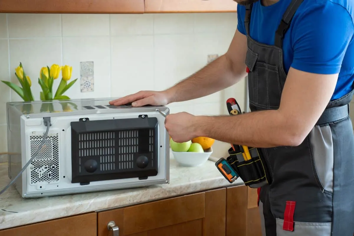 Young repairman fixing and repai