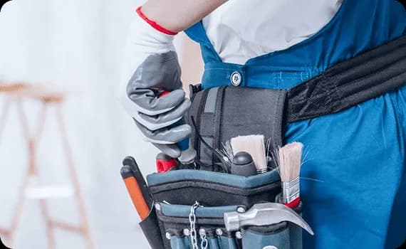 Appliance repair engineer wearing a tool belt